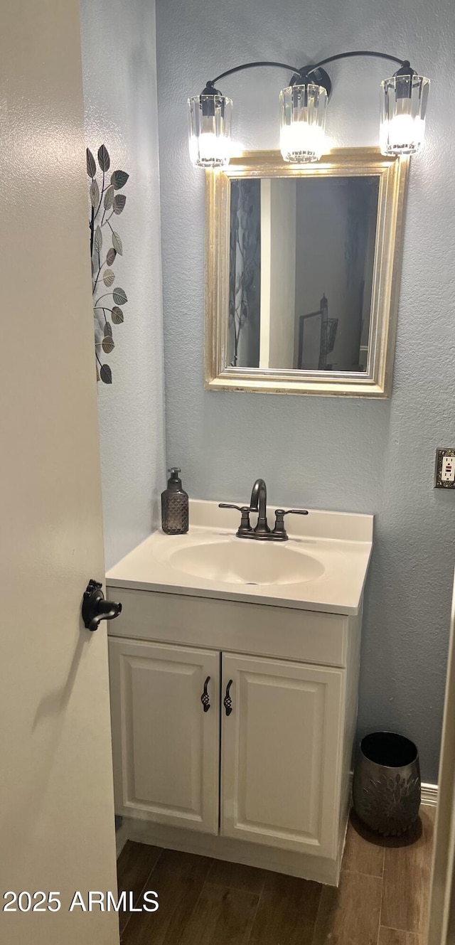bathroom with wood finish floors and vanity