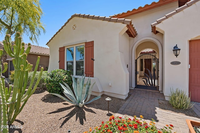 30406 N 54th St, Cave Creek, AZ 85331 - view of exterior entry featuring a tiled roof and stucco siding