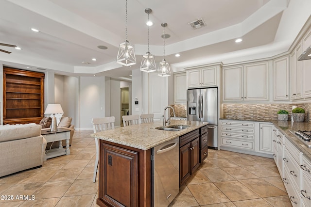 30406 N 54th St, Cave Creek, AZ 85331 - kitchen featuring appliances with stainless steel finishes, a raised ceiling, a sink, open floor plan, and backsplash