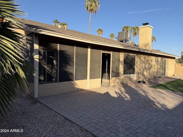 rear view of property with a patio and a sunroom