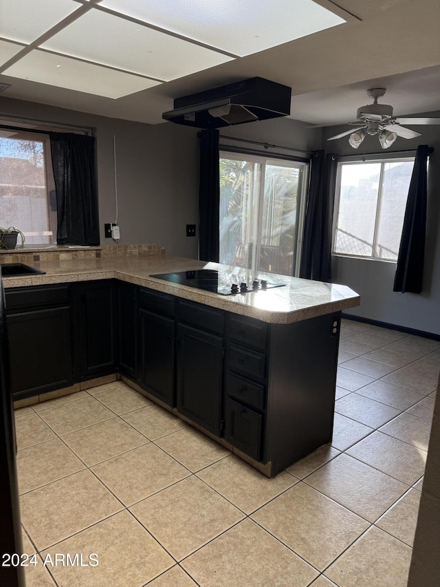 kitchen with ceiling fan, black electric cooktop, and a wealth of natural light