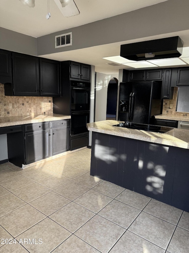 kitchen with light tile patterned flooring, tasteful backsplash, and black appliances