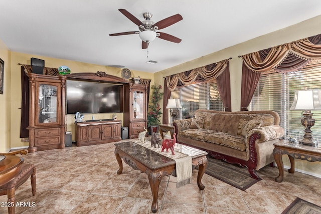 tiled living room with ceiling fan and a healthy amount of sunlight