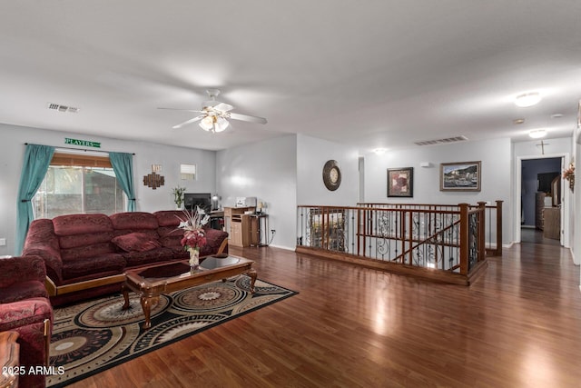 living room featuring dark hardwood / wood-style flooring and ceiling fan