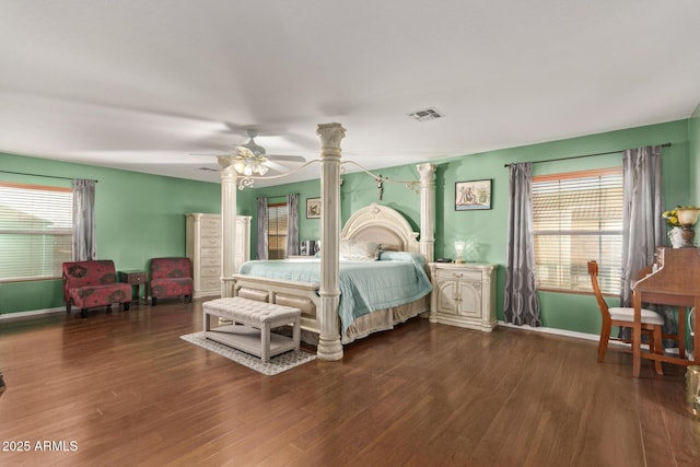 bedroom with ceiling fan, dark hardwood / wood-style floors, and multiple windows