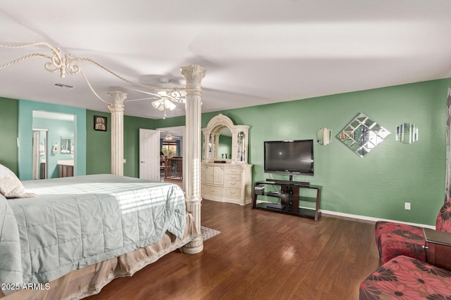 bedroom with decorative columns, ceiling fan, and dark wood-type flooring