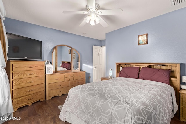 bedroom with ceiling fan and dark wood-type flooring