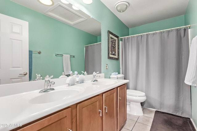 bathroom featuring tile patterned floors, vanity, and toilet