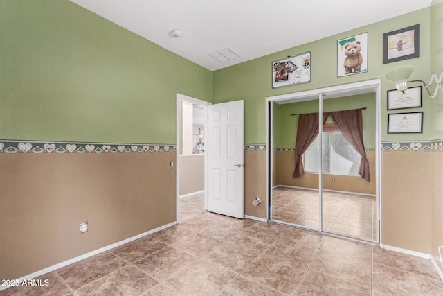 unfurnished bedroom featuring a closet and tile patterned flooring