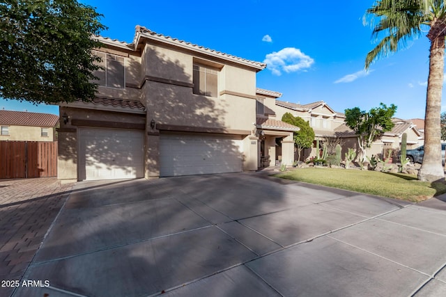 mediterranean / spanish home with a front yard and a garage