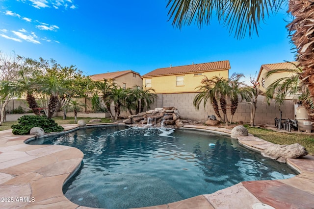 view of swimming pool with pool water feature