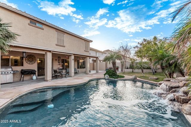 view of pool featuring grilling area and a patio