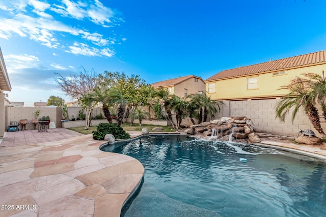 view of pool with pool water feature and a patio area