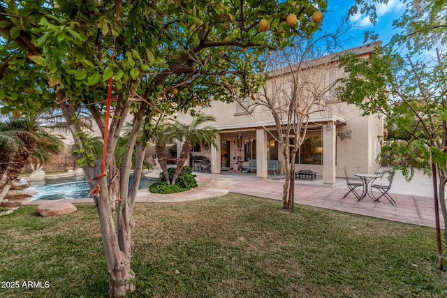 rear view of property featuring a lawn