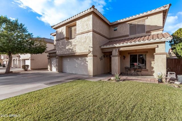 mediterranean / spanish-style house featuring a front lawn and a garage