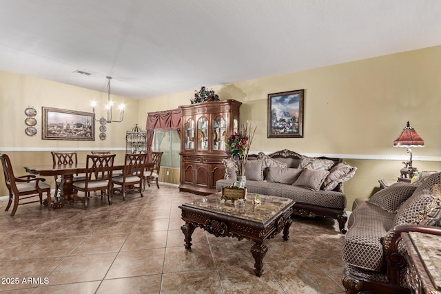 tiled living room featuring a notable chandelier