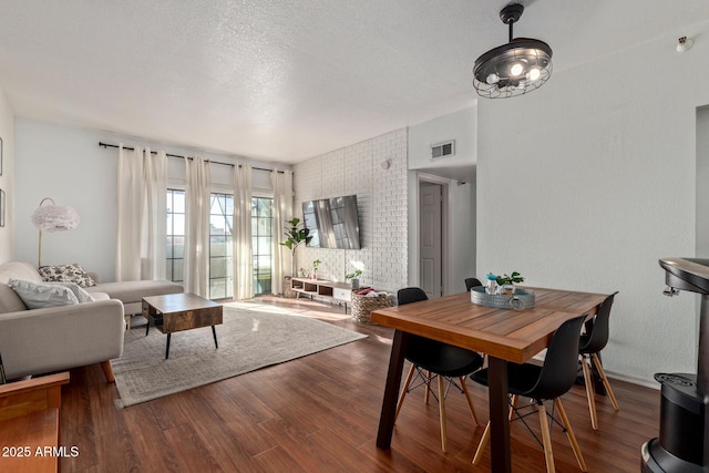 living room featuring a textured ceiling and hardwood / wood-style floors