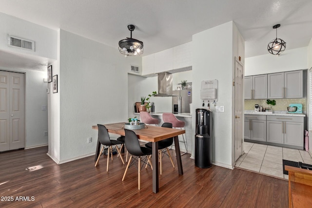 dining space with wood-type flooring