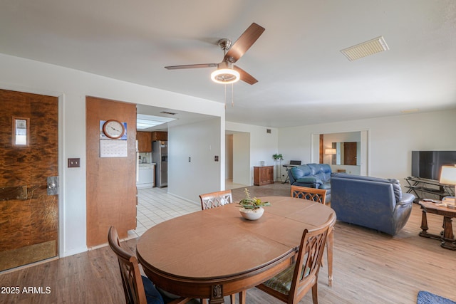 dining room featuring light hardwood / wood-style flooring and ceiling fan