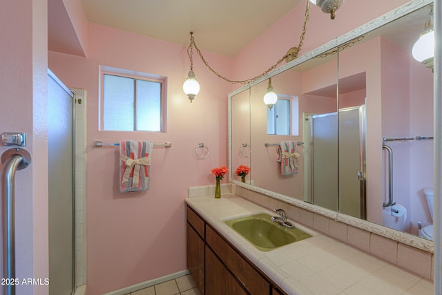 bathroom with vanity, tile patterned floors, toilet, and walk in shower