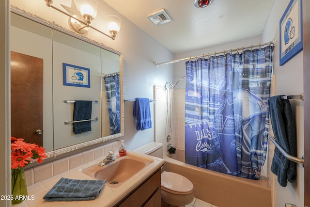 full bathroom with tile patterned flooring, shower / bath combo, vanity, and toilet