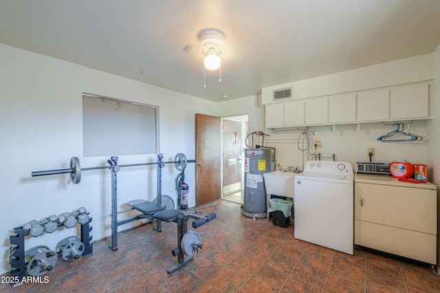 clothes washing area featuring water heater, independent washer and dryer, sink, and cabinets