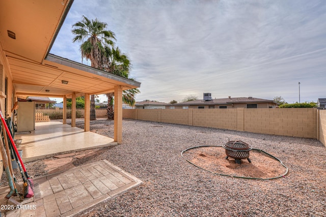 view of yard with a patio area and an outdoor fire pit