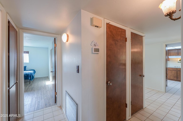 hallway featuring light tile patterned floors