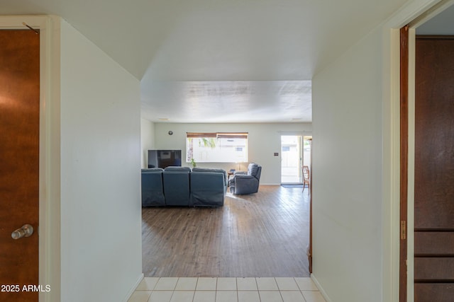 hall with light tile patterned floors