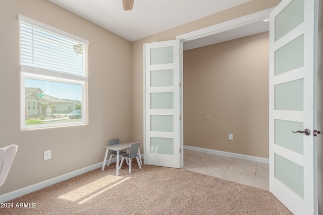 carpeted empty room featuring lofted ceiling and ceiling fan