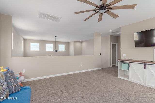 interior space featuring carpet flooring and ceiling fan