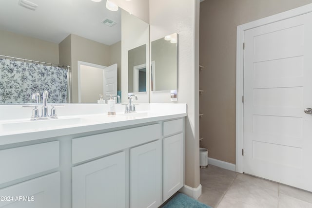 bathroom featuring tile patterned flooring and vanity