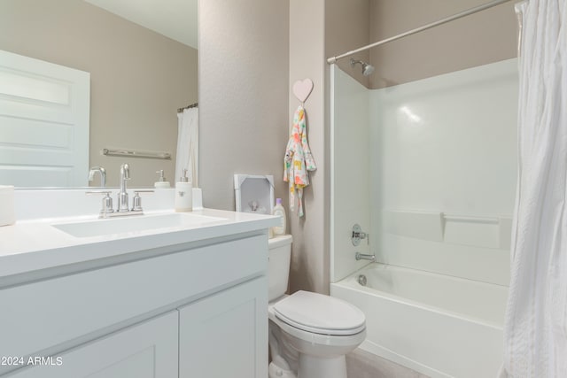 full bathroom featuring vanity, shower / bath combo with shower curtain, and toilet