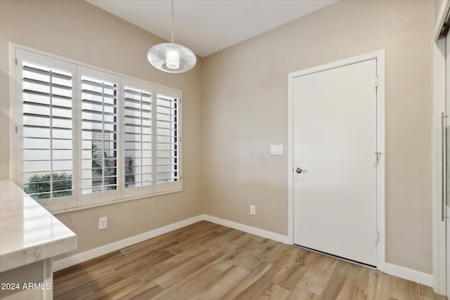 unfurnished dining area with a healthy amount of sunlight and light wood-type flooring