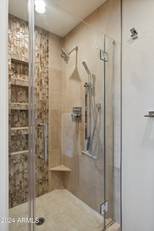 bathroom with a shower with door