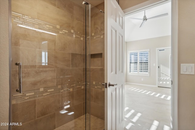 bathroom with ceiling fan and an enclosed shower