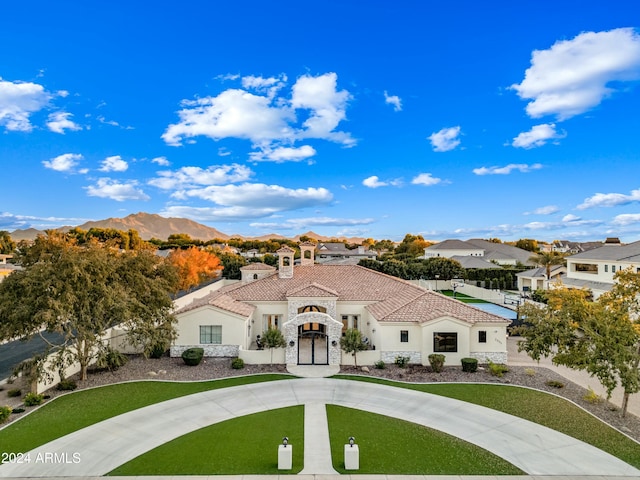 2335 E Plum St, Gilbert, AZ 85298 - mediterranean / spanish home with stucco siding, stone siding, a tiled roof, and a residential view