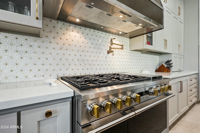 2335 E Plum St, Gilbert, AZ 85298 - kitchen featuring high end range, wall chimney range hood, light countertops, glass insert cabinets, and decorative backsplash
