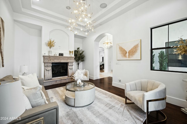 2335 E Plum St, Gilbert, AZ 85298 - living area with arched walkways, baseboards, wood finished floors, a premium fireplace, and a tray ceiling