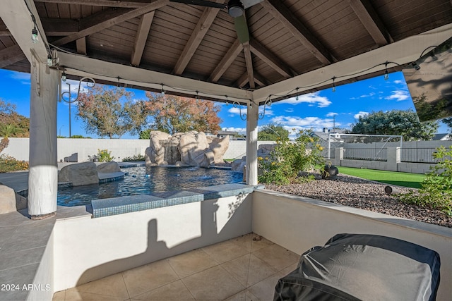 view of patio / terrace featuring a gazebo, pool water feature, and a fenced in pool