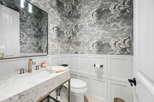 2335 E Plum St, Gilbert, AZ 85298 - bathroom featuring a wainscoted wall, toilet, a decorative wall, and vanity