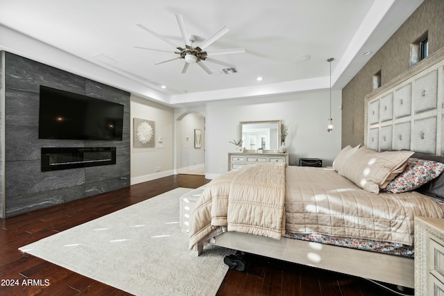 2335 E Plum St, Gilbert, AZ 85298 - bedroom featuring arched walkways, wood finished floors, recessed lighting, a fireplace, and baseboards