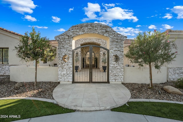 2335 E Plum St, Gilbert, AZ 85298 - entrance to property featuring a gate, stucco siding, stone siding, and a tiled roof