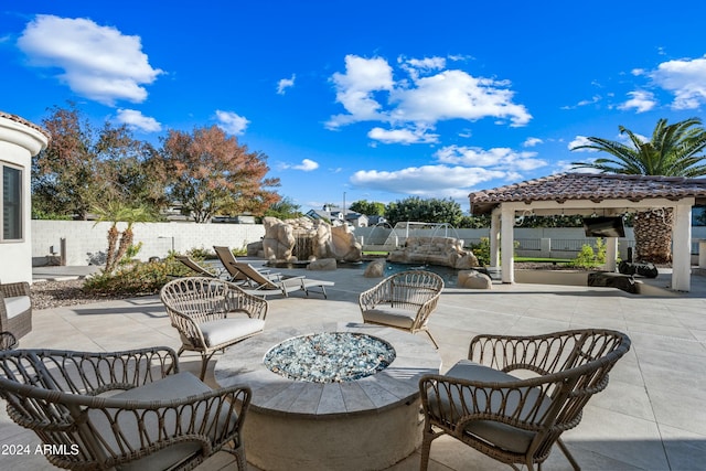 view of patio / terrace featuring a gazebo and an outdoor fire pit