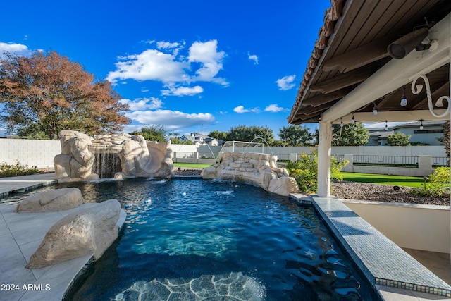 view of pool featuring pool water feature and a water slide