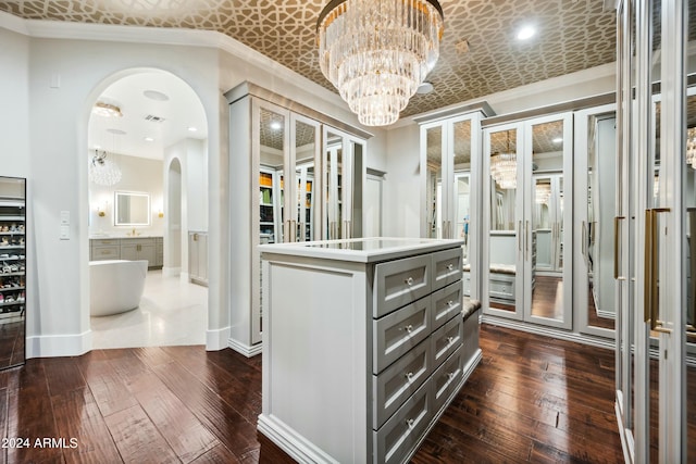 2335 E Plum St, Gilbert, AZ 85298 - walk in closet featuring arched walkways, a chandelier, and dark wood-type flooring