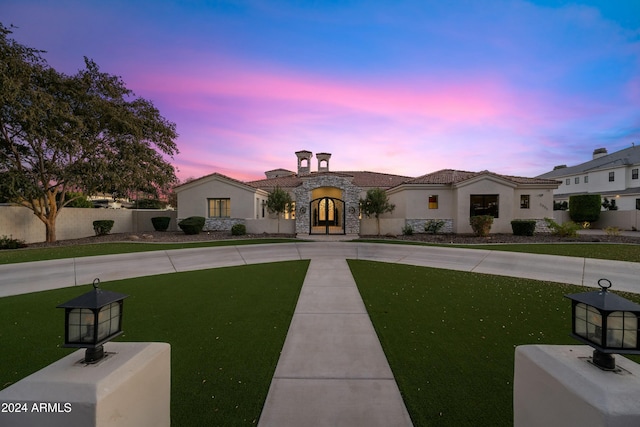 view of front of house with a yard