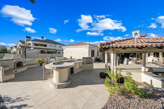 2335 E Plum St, Gilbert, AZ 85298 - view of patio with exterior bar and a fireplace with raised hearth