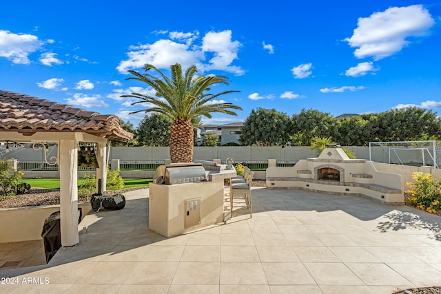 2335 E Plum St, Gilbert, AZ 85298 - view of patio / terrace featuring a fireplace with raised hearth, area for grilling, and a gazebo