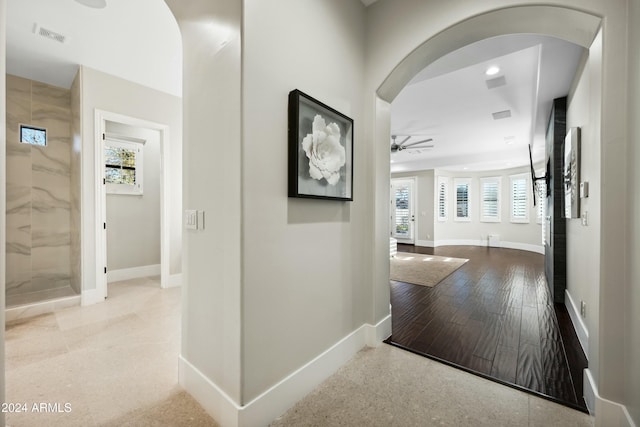 hallway with light hardwood / wood-style floors